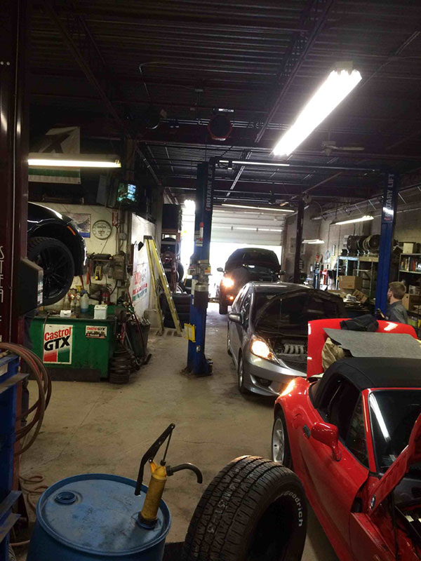 Busy workshop with multiple vehicles being serviced